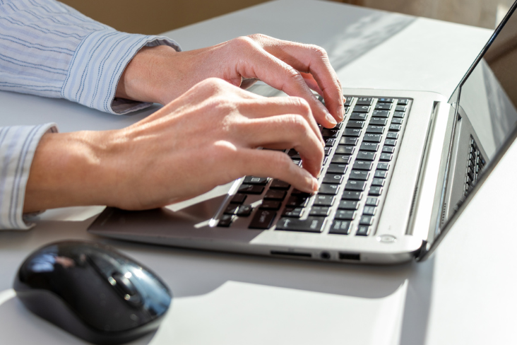 Person typing on laptop
