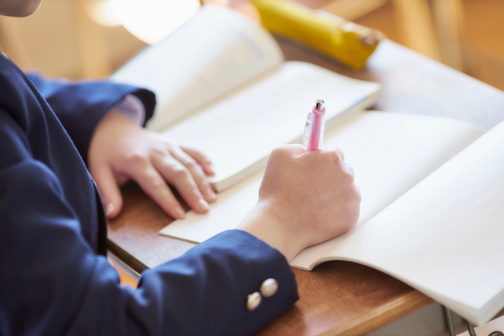 Person writing on a blank page