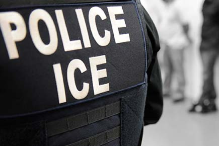 Immigration and Customs Enforcement (ICE) Uniform viewed from behind with large "POLICE ICE" text visible.